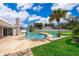 Beautiful backyard pool with blue lounge chairs, palm trees, and plenty of sunshine at 2223 Fairmont Cir, Orlando, FL 32837