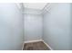 Empty walk-in closet with built-in shelving and tile flooring at 2223 Fairmont Cir, Orlando, FL 32837