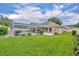 Expansive backyard featuring a screened pool enclosure, lush green lawn, and well-maintained landscaping at 2265 Turnberry Dr, Oviedo, FL 32765