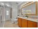 Stylish bathroom with dual sinks, tile flooring, and modern fixtures at 2265 Turnberry Dr, Oviedo, FL 32765