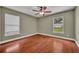 Empty bedroom features hardwood floors, two windows, and neutral paint at 2265 Turnberry Dr, Oviedo, FL 32765