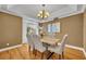 Elegant dining room features a chandelier, natural light, and seating for six at 2265 Turnberry Dr, Oviedo, FL 32765
