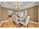Elegant dining room with hardwood floors, stylish chandelier, and comfortable seating for formal meals at 2265 Turnberry Dr, Oviedo, FL 32765