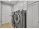 Efficient laundry room featuring a modern washer and dryer, plus ample storage with sleek white cabinets at 2265 Turnberry Dr, Oviedo, FL 32765