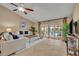 Bright living room with tile floors, a cozy seating arrangement, and sliding doors to the pool area at 2265 Turnberry Dr, Oviedo, FL 32765