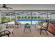 Relaxing screened pool patio offering comfortable seating, a hot tub, and views of the lush backyard at 2265 Turnberry Dr, Oviedo, FL 32765