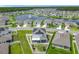 Aerial view of a neighborhood featuring modern homes with solar panels and a scenic lake at 242 White Heron Way, St Cloud, FL 34772