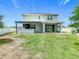 Backyard view of a two story home with a covered patio and outdoor kitchen at 242 White Heron Way, St Cloud, FL 34772