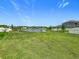 Expansive backyard overlooking a serene lake with a fountain, offering a peaceful outdoor retreat at 242 White Heron Way, St Cloud, FL 34772