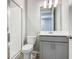 A stylish bathroom featuring a glass-enclosed shower, toilet, and modern vanity with mirror at 242 White Heron Way, St Cloud, FL 34772