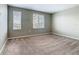Bedroom featuring two windows with blinds and neutral carpet at 242 White Heron Way, St Cloud, FL 34772
