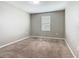 Bedroom with neutral walls, carpeted flooring, and a window with blinds at 242 White Heron Way, St Cloud, FL 34772