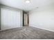 Bedroom featuring closet, gray walls, neutral carpet, and an open doorway at 242 White Heron Way, St Cloud, FL 34772