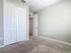 A well-lit bedroom with carpet, closet, and doorway to other room at 242 White Heron Way, St Cloud, FL 34772