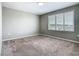Bedroom with window and view of neighborhood, neutral walls and carpet at 242 White Heron Way, St Cloud, FL 34772