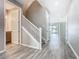 Welcoming entryway featuring wood-look flooring, staircase, and access to various rooms at 242 White Heron Way, St Cloud, FL 34772