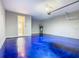 Bright garage featuring an epoxy floor and a doorway to the home's interior at 242 White Heron Way, St Cloud, FL 34772