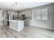 Kitchen features a large island with a sink, stainless steel appliances, a mosaic tile backsplash, and recessed lighting at 242 White Heron Way, St Cloud, FL 34772