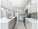 Modern kitchen boasts stainless steel appliances, gray cabinets, mosaic tile backsplash, and a quartz countertop island at 242 White Heron Way, St Cloud, FL 34772