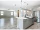 Open-concept kitchen features a large island with a sink, stainless steel appliances, and pendant lighting at 242 White Heron Way, St Cloud, FL 34772