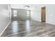 Spacious living room features wood-look floors, ample natural light from windows, and a modern ceiling fan at 242 White Heron Way, St Cloud, FL 34772