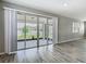 The living space has sliding glass doors that open to the patio area with views of the fenced backyard at 242 White Heron Way, St Cloud, FL 34772