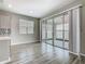 Living space with sliding glass doors that open onto a screened lanai, plus a view of the kitchen area at 242 White Heron Way, St Cloud, FL 34772