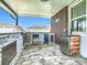 Outdoor kitchen featuring a built-in grill, mini fridge, ice maker, and bar on a brick patio at 242 White Heron Way, St Cloud, FL 34772
