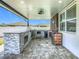 Outdoor kitchen with a built-in grill, a mini fridge, and an ice maker on the covered patio at 242 White Heron Way, St Cloud, FL 34772
