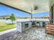 Outdoor kitchen featuring a built-in grill, stainless steel storage, and stone backsplash, surrounded by pavers at 242 White Heron Way, St Cloud, FL 34772