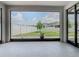 View of the backyard from covered patio with white fences and green lawn on a sunny day at 242 White Heron Way, St Cloud, FL 34772