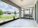 View from the covered patio of the backyard with outdoor kitchen, barbecue, and white fences at 242 White Heron Way, St Cloud, FL 34772