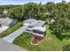 High-angle view of the property showcasing the well-maintained home with landscaped yard at 25333 Casa Del Lago Ln, Leesburg, FL 34748