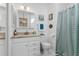 A clean bathroom with a vanity, mirror, and shower at 25333 Casa Del Lago Ln, Leesburg, FL 34748
