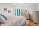 A well-lit bedroom with a bed, dresser, and two windows at 25333 Casa Del Lago Ln, Leesburg, FL 34748