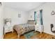 A cozy bedroom featuring hardwood floors and a comfortable bed at 25333 Casa Del Lago Ln, Leesburg, FL 34748