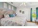 A light and airy bedroom with a decorative headboard, a ceiling fan, and natural light at 25333 Casa Del Lago Ln, Leesburg, FL 34748
