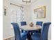 A dining area featuring a marble table with blue chairs and decor at 25333 Casa Del Lago Ln, Leesburg, FL 34748