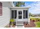Well-maintained front porch featuring brick stairs, vibrant planters, and a charming welcome mat at 25333 Casa Del Lago Ln, Leesburg, FL 34748