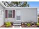 Charming front entrance with vibrant landscaping and a welcoming entryway at 25333 Casa Del Lago Ln, Leesburg, FL 34748