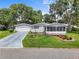 Well-maintained single-story home with an attached garage and beautiful landscaping at 25333 Casa Del Lago Ln, Leesburg, FL 34748