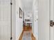 A long hallway leading to the kitchen, highlighting hardwood floors at 25333 Casa Del Lago Ln, Leesburg, FL 34748