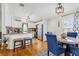 Bright kitchen area with white cabinets and stainless steel appliances, adjacent to a cozy dining space at 25333 Casa Del Lago Ln, Leesburg, FL 34748
