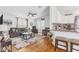 Cozy living space featuring hardwood floors, neutral-toned furniture, and an open-concept layout at 25333 Casa Del Lago Ln, Leesburg, FL 34748