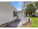 View of side exterior with a white picket fence leading to backyard at 25333 Casa Del Lago Ln, Leesburg, FL 34748
