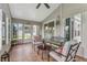 Cozy sunroom with tile flooring, ceiling fan, and comfortable seating, perfect for relaxation at 25333 Casa Del Lago Ln, Leesburg, FL 34748