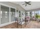 Inviting sunroom features ceiling fan, tile floors and an abundance of natural light at 25333 Casa Del Lago Ln, Leesburg, FL 34748