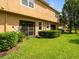 A spacious backyard with green grass, a patio door, and mature landscaping at 2918 Rodrick Cir, Orlando, FL 32824