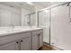 Bathroom featuring double sink vanity, walk-in shower with glass door, and ceramic tile flooring at 2918 Rodrick Cir, Orlando, FL 32824