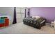 Bedroom with gray carpet, a purple accent wall, and an aquarium at 2918 Rodrick Cir, Orlando, FL 32824